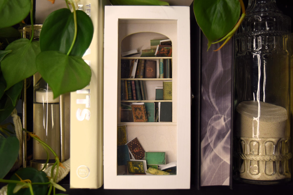 The Nook white Shake-A-Shelf miniature bookshelf with tiny books