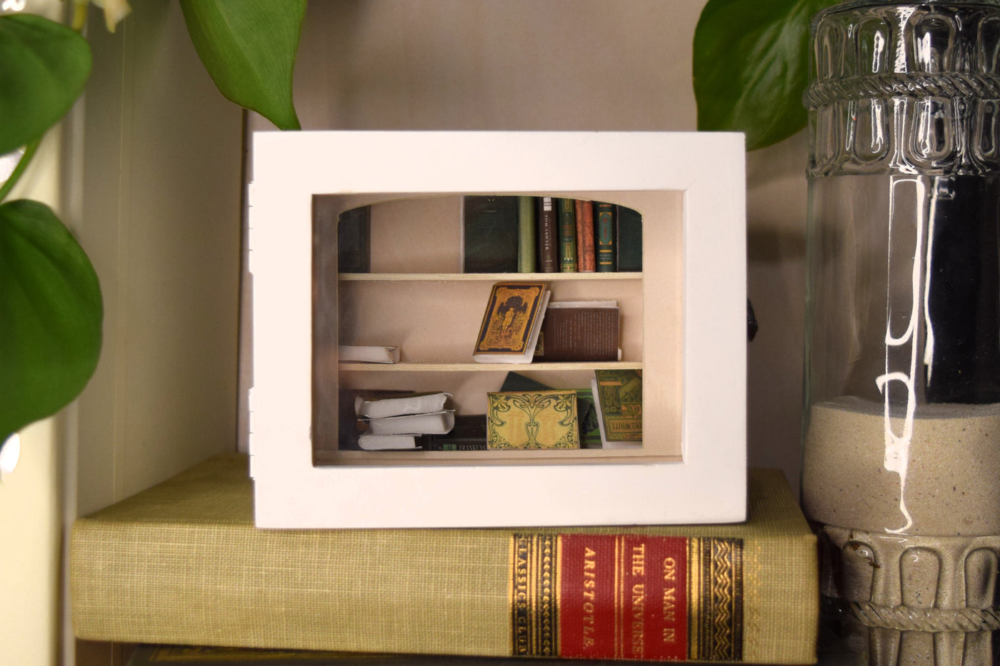 The Short Stack white Shake-A-Shelf miniature bookshelf with tiny books